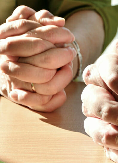 Close-up of two hands clasped in prayer